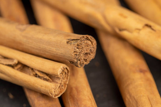 istock Thick wooden cinnamon on a black slate board 2186335684