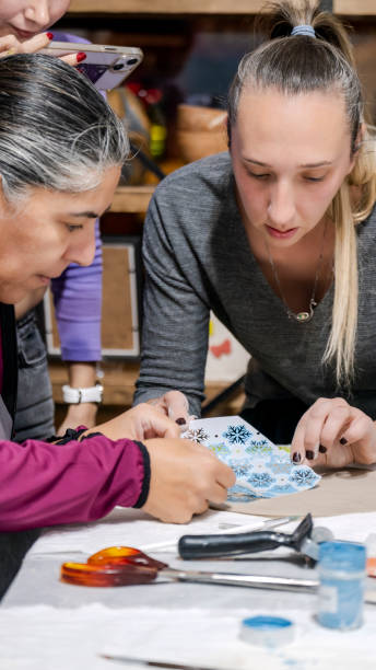 istock In an art studio with an environment adorned with artistic paintings in the background, two beautiful middle-aged artist friends are working on clay shaping at a table 2186336336