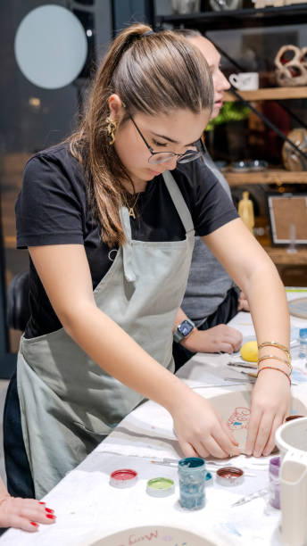 istock A young girl shapes clay in an art studio during an art activity 2186337725