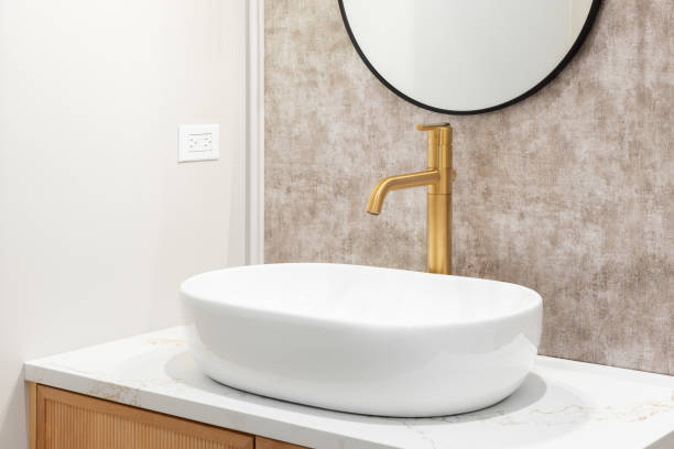istock A bathroom's white vessel sink with a gold faucet. 2186337732