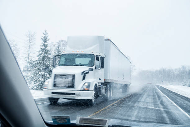 istock Semi Truck Speeding on Winter Blizzard Snow Highway 2186338499