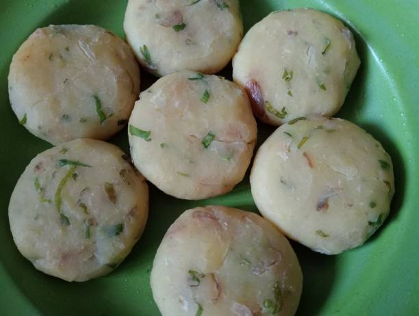istock Uncooked Potato Patties on a Green Plate 2186338826