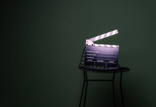 Movie Clapper on a high chair over green background