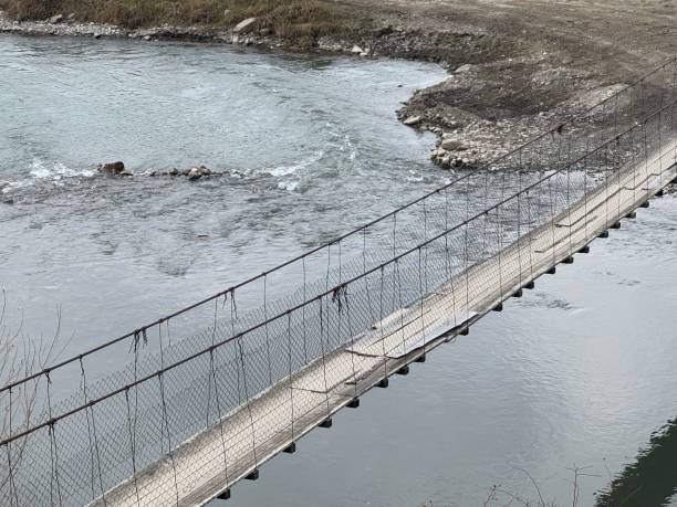 istock A pedestrian bridge over a mountain river 2186339886