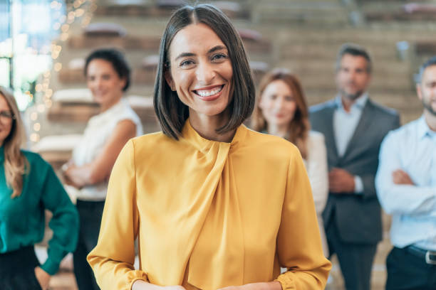 istock Confident business woman and her team 2186340169