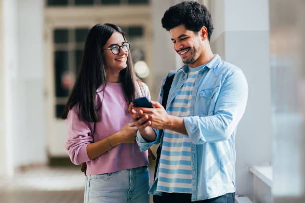 istock Young Friends Enjoying a Lighthearted Moment With a Smartphone 2186344116