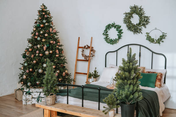 istock Cozy bedroom with a Christmas tree and holiday greenery 2186345559
