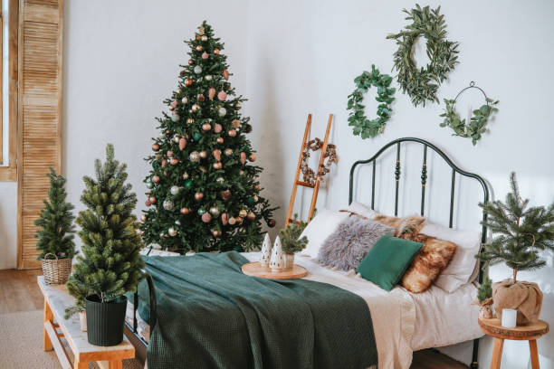istock Cozy bedroom decorated for Christmas with a tree and festive greenery 2186345574