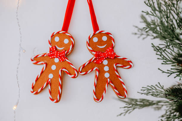 istock Gingerbread cookies with red bows hanging on a festive backdrop during winter 2186346008