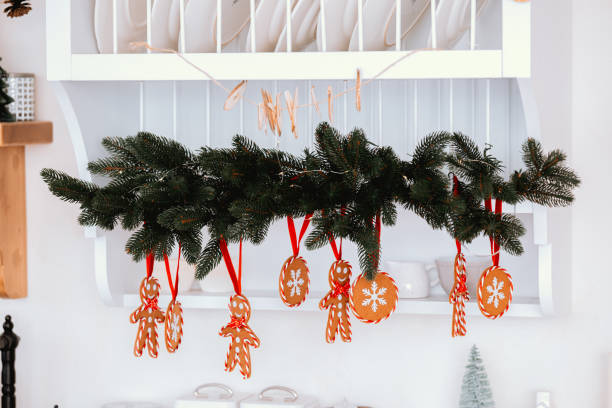 istock Festive gingerbread decorations hanging in a cozy kitchen for the holidays 2186346014