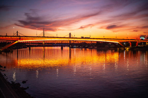Illuminated Gazela bridge over river Sava in Belgrade at sunset