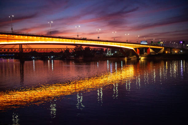 Illuminated Gazela bridge over river Sava in Belgrade at sunset