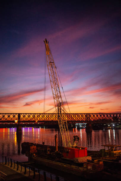 Construction yard on the Sava riverbank in Belgrade against moody sunset