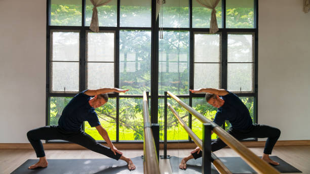 istock Caucasian man practicing yoga exercise at yoga studio. 2186356793