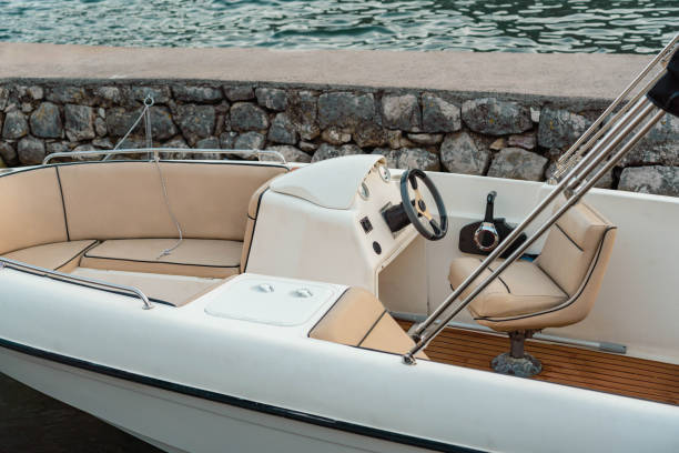 istock A sleek and modern motorboat with comfortable seating, docked by the shore, perfect for leisure and exploration on the water. 2186362262