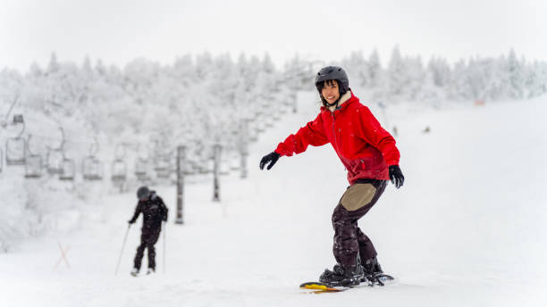istock Asian woman practice snowboarding at ski area 2186369342