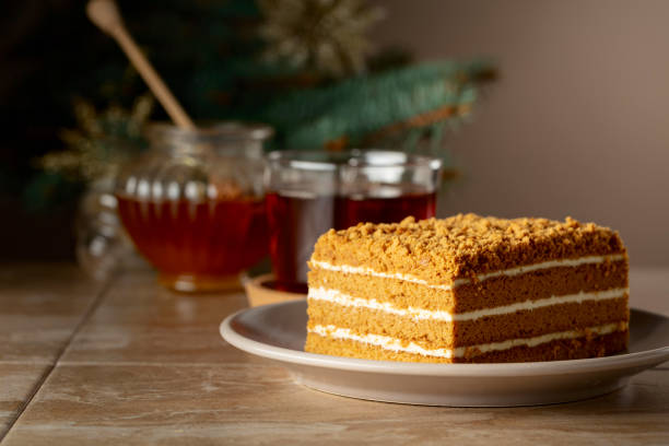 istock Layered honey cake on a background of Christmas tree. 2186371865