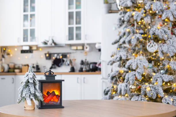 istock Cozy Christmas decor tiny house of small size on table of festive white modern kitchen. Gift for New Year. Insurance, moving to new house, mortgage, rent and purchase real estate 2186376321