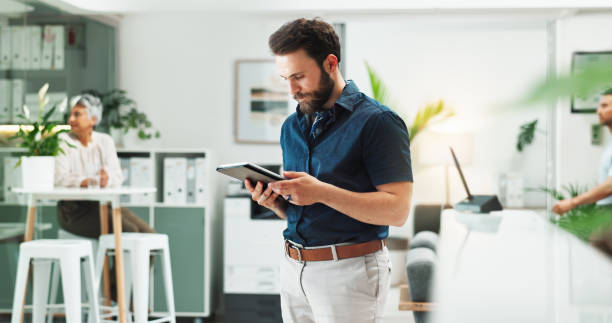 istock Business people, typing and man in office, tablet and network with internet, connection and social media. Person, consulting agency and employee in workplace, tech and communication with digital app 2186384072