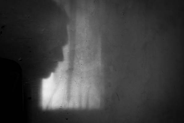 istock Shadow of a person on the wall 2186392212