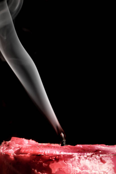 istock Smoke from an extinguished candle in a dark place 2186392740
