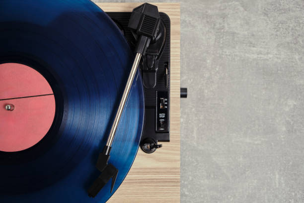 istock Vinyl record player with blue record installed top view gray background. 2186402973