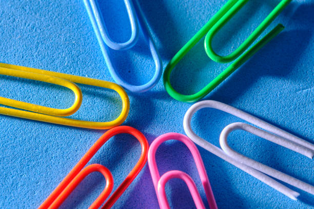 istock Multi colored paper clips are folded in shape star blue background. 2186403034