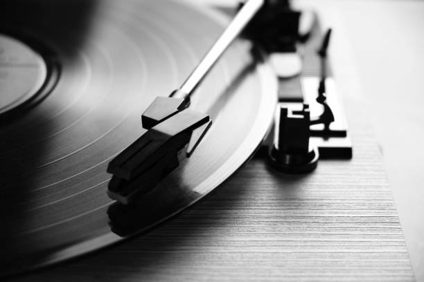 Classic vinyl record player closeup with contoured daylight from window in black and white photo