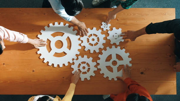 istock Top view of business people gathering white gear together at table. Convocation. 2186403505