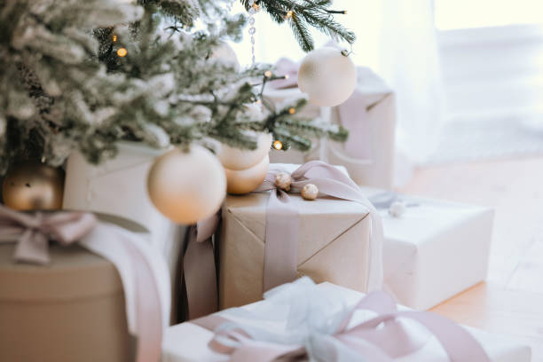 istock Elegant white and gold Christmas presents under a decorated holiday tree 2186409578