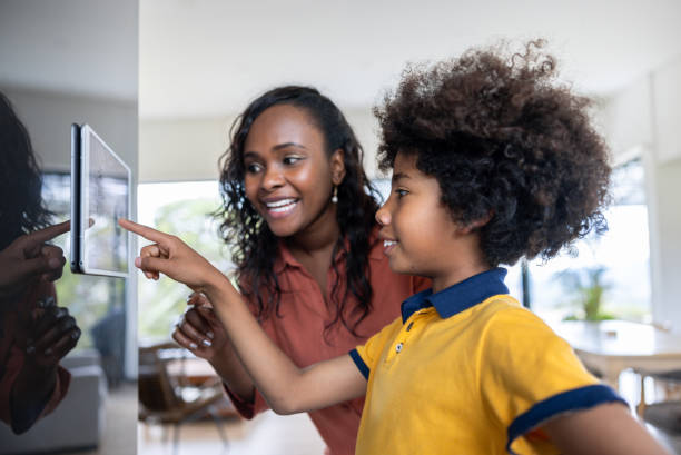 istock Mother and son using a home automation system in their new smart house 2186412099