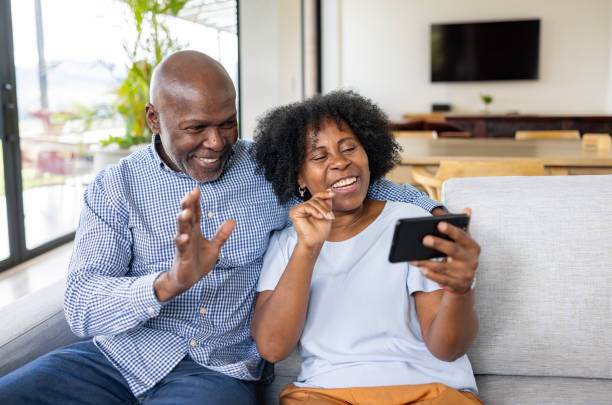 istock Happy senior couple taking a video call at home 2186412102