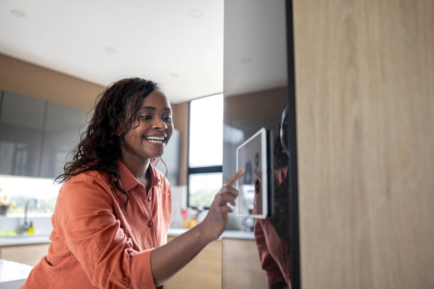istock Woman using a home automation system to control the music 2186412105