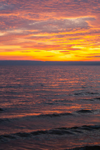 istock a colorful sky with the sun setting behind clouds 2186413109