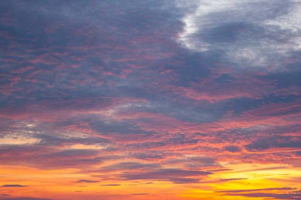 istock a colorful sky with the sun setting behind clouds 2186413132