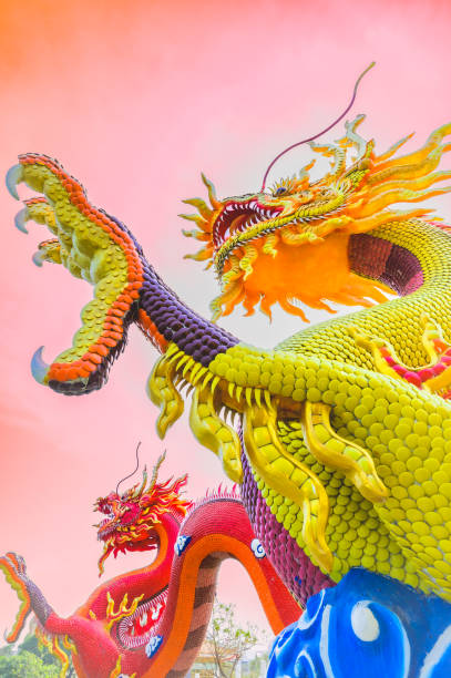 Dragon statue in Chinese style with beautiful sky. The dragon sculpture is a landmark of Nakhon Sawan Province. Red and yellow dragon.