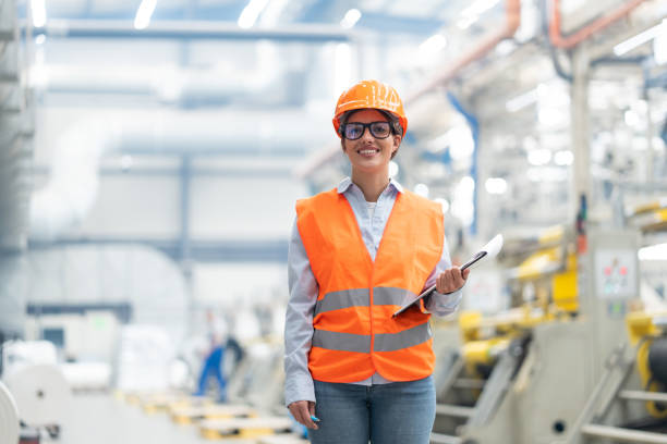 istock Confident female engineer in vivid factory with tablet, enthusiastic about technological advances. 2186414133