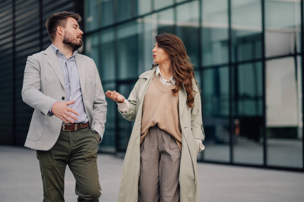 istock Businesspeople having conversation while walking outdoors 2186416550