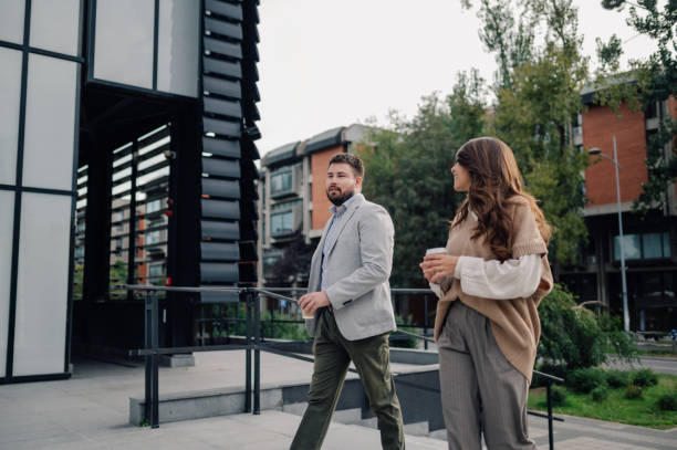 istock Business people walking and talking about work outside office building 2186416564