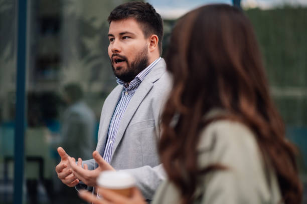 istock Businessman explaining something to colleague holding coffee 2186416601