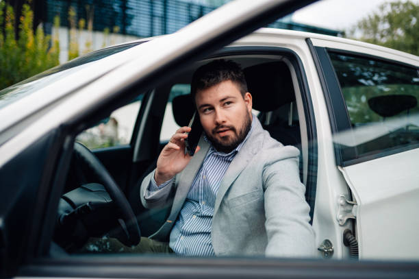 istock Businessman talking on phone while sitting in car 2186416604