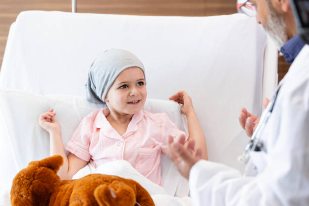istock Pediatric oncologist talks with little girl 2186419361