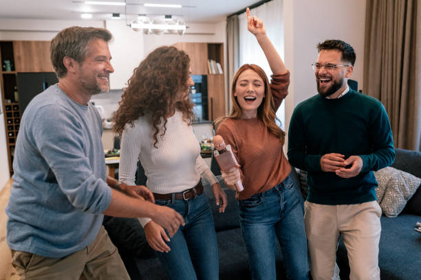istock Friends playing karaoke at home 2186419816
