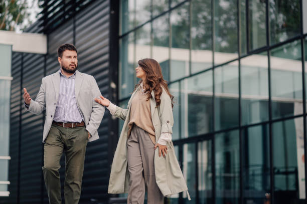 istock Businesspeople discussing while walking near office building 2186421192