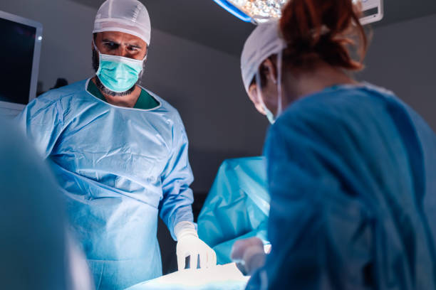 istock Surgeons focus intently on an intricate surgical procedure. 2186421691