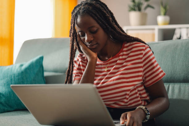 istock Young woman looking bored and tired while working from home on her laptop 2186421976