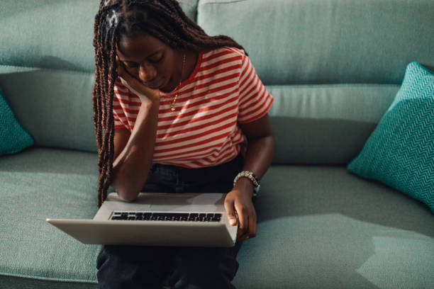 istock Young woman working from home is feeling tired and stressed using laptop on the sofa 2186421982
