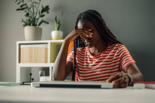 istock Stressed young woman suffering from headache while working from home office 2186422006