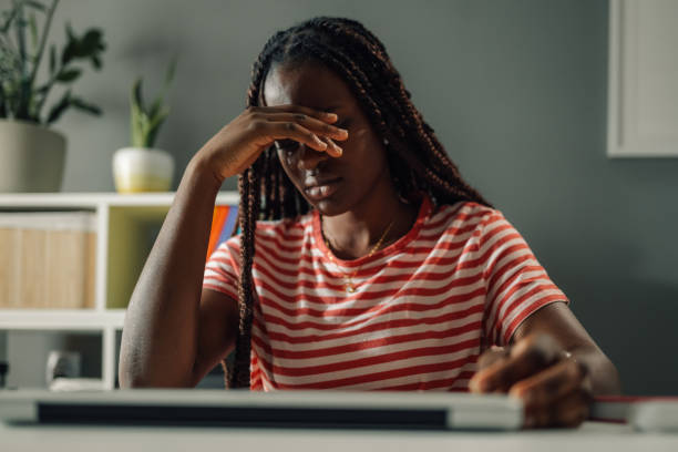 istock Stressed young woman suffering from headache while working from home 2186422013