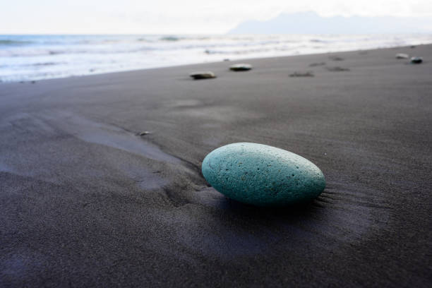 Green Stone on Penggajava Beach with Black Sand on Flores Island, Indonesia